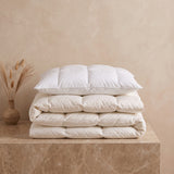 Down alternative duvet and pillow, baffle-box construction, on a marble plinth
