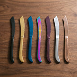 New York Knife — jewel-toned dinner knives on a warm wood table