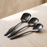 Close-up of the Singapore Serving Spoon glossy black finish