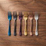 Barcelona Salad Fork — jewel-toned salad forks on a warm wood table