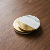 Marble Coaster — marble and gold drink coasters on a warm wood table