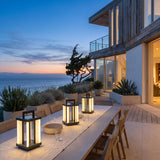 Contemporary Lamp lanterns lighting an outdoor dining table at dusk