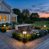 Nimbus Cube Solar Light lighting an outdoor dining terrace at dusk