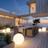Element Lamp lighting an outdoor dining terrace at dusk