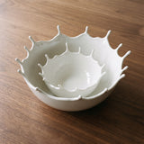 Splash Bowl — sculptural gallery view on a warm wood table