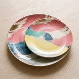 Picasso Plate Collection — abstract painted plates on a warm wood table