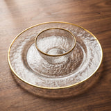 Opaque Plate Collection — gold-rimmed hammered glass on a warm wood table