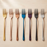 London Fork — jewel-toned dinner forks on a warm wood table