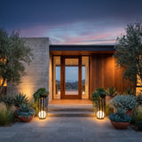 A matched pair of Flower Pot Lamps flanking a modern front entrance at dusk