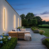 Stripe Lined Wall Lights mounted above outdoor lounge seating at dusk
