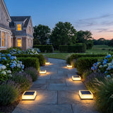 Flat Out Lights lighting a stone garden path at dusk