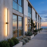 A run of Luminous Line Outdoor Lights along a house facade at dusk