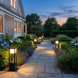 Nimbus Cube Solar Light lighting a stone garden path at dusk