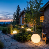 Element Lamp set among garden planting at dusk