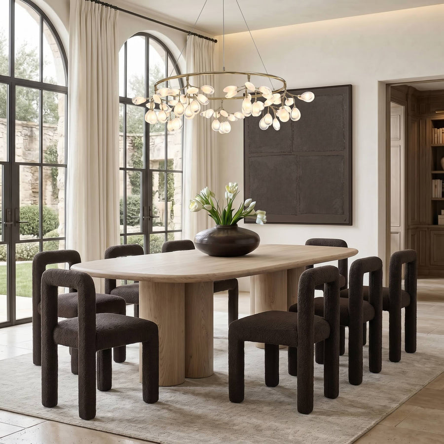 The Mary round table styled with sculptural dining chairs