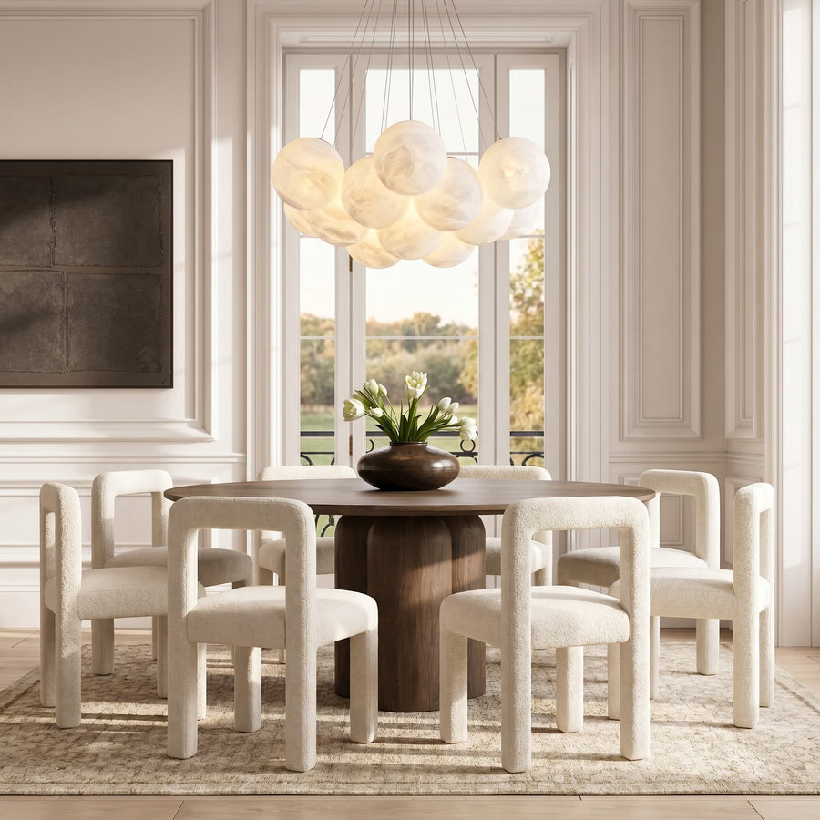 Ames dining chairs in cream bouclé in a sunlit dining space