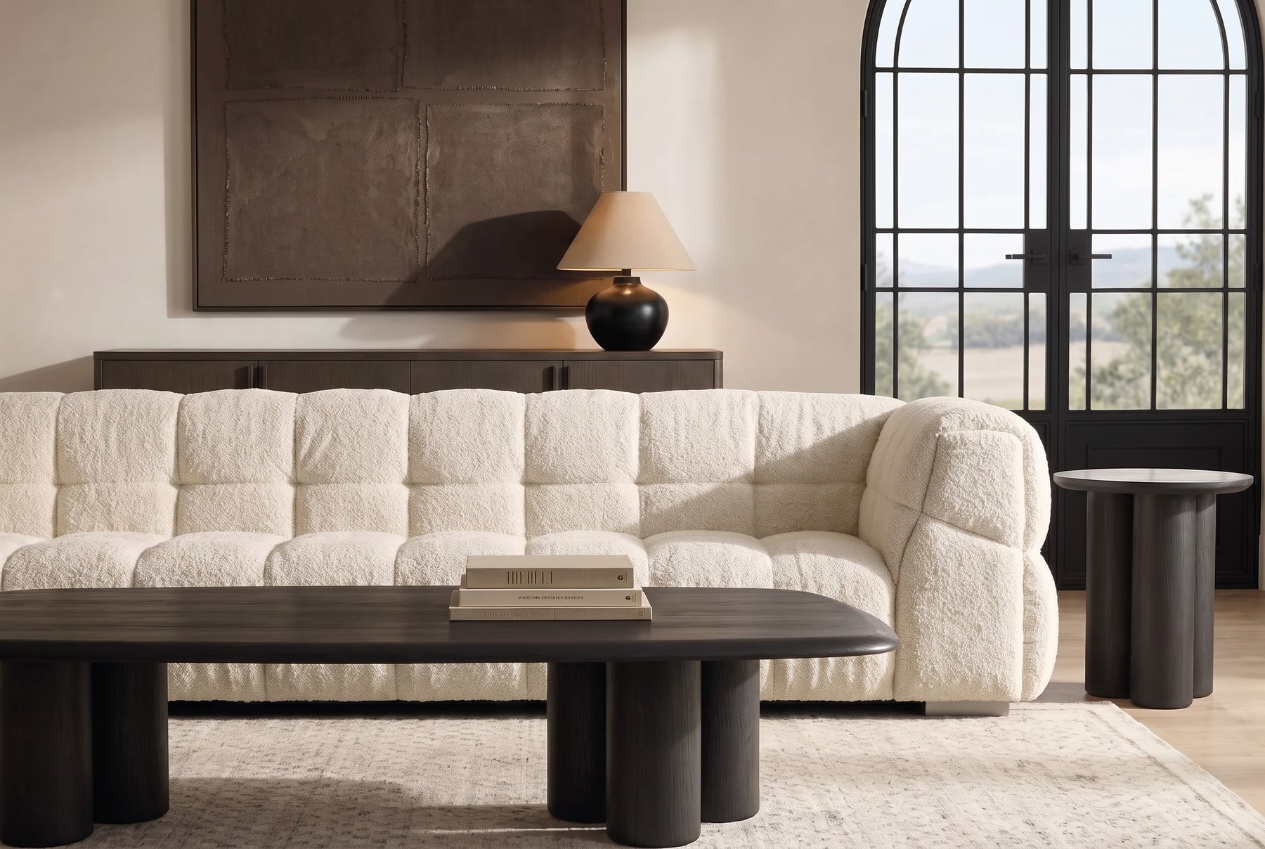 A modern rustic living room with a deep bouclé sofa, fluted walnut coffee table and warm plaster walls