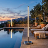 Lamps beside a pool at dusk